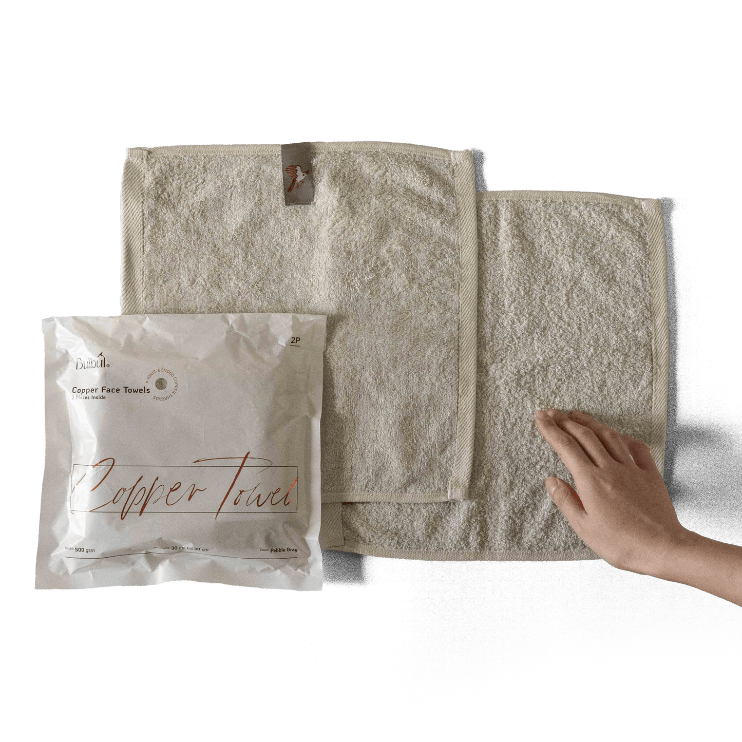 Bulbul Self-sanitizing Premium Copper Face Towel shown with packaging and hand for scale. Antibacterial and odour-resistant washcloth for home use.