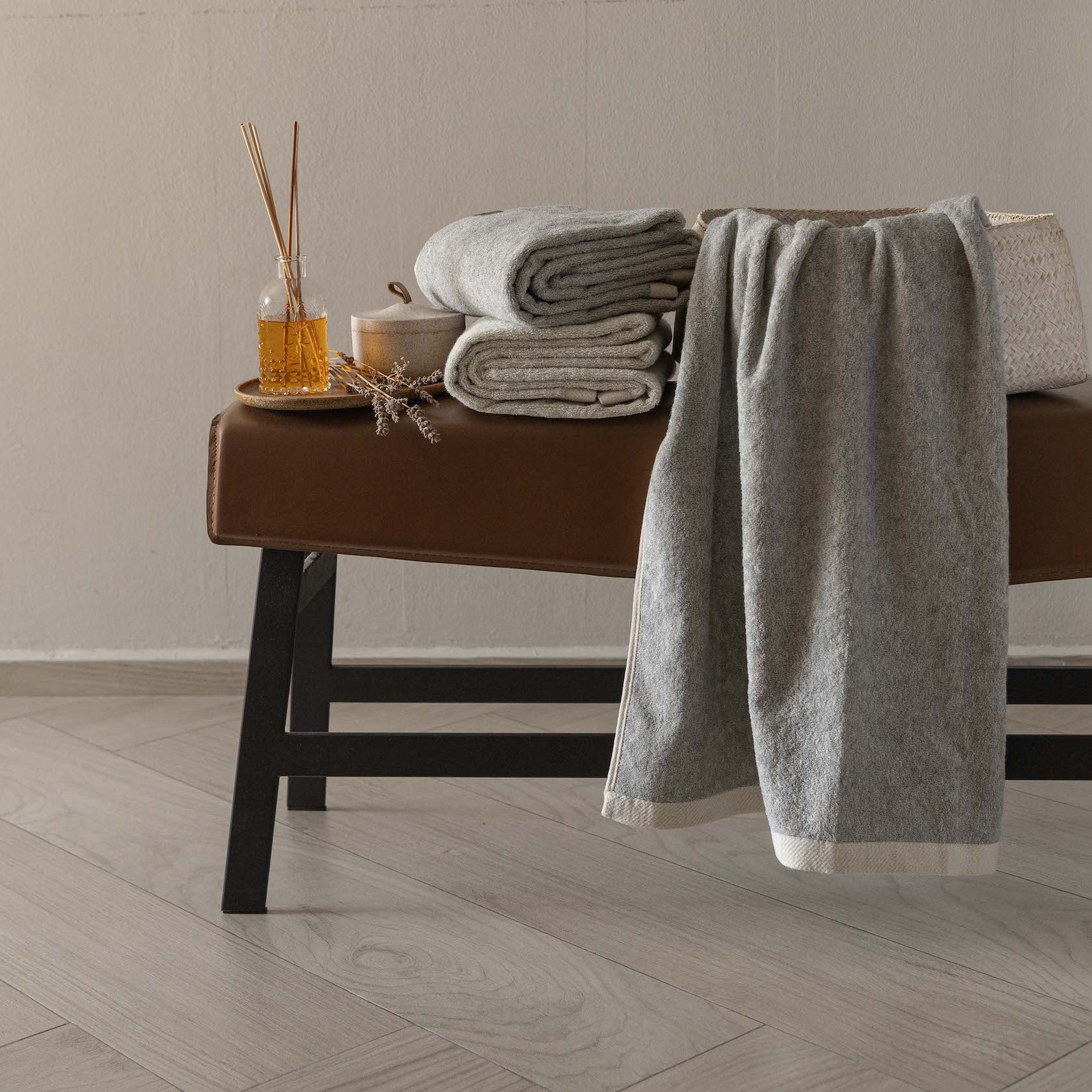 Bulbul Self-sanitizing Premium Copper Bath Towel in soft grey draped on a bench, antibacterial and odour-resistant for home and pet-friendly use.