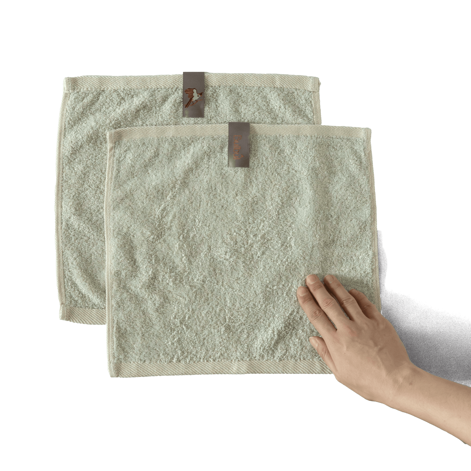 Bulbul Self-sanitizing Premium Copper Face Towel shown in beige color with hand for scale, antibacterial and odour-resistant washcloth for home use.