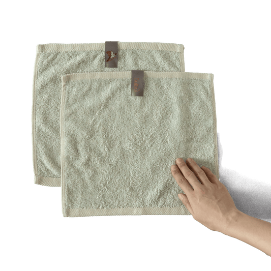 Bulbul Self-sanitizing Premium Copper Face Towel shown in beige color with hand for scale, antibacterial and odour-resistant washcloth for home use.