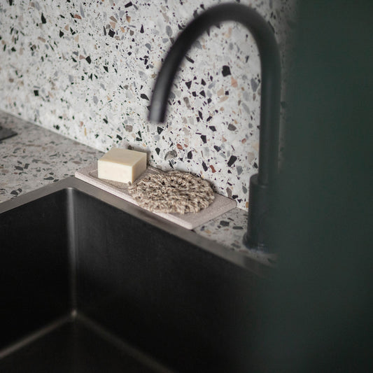 Bulbul diatomite soap dish, tray and holder arranged on a bathroom sink