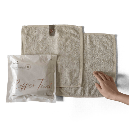 Bulbul Self-sanitizing Premium Copper Face Towel shown with packaging and hand for scale. Antibacterial and odour-resistant washcloth for home use.